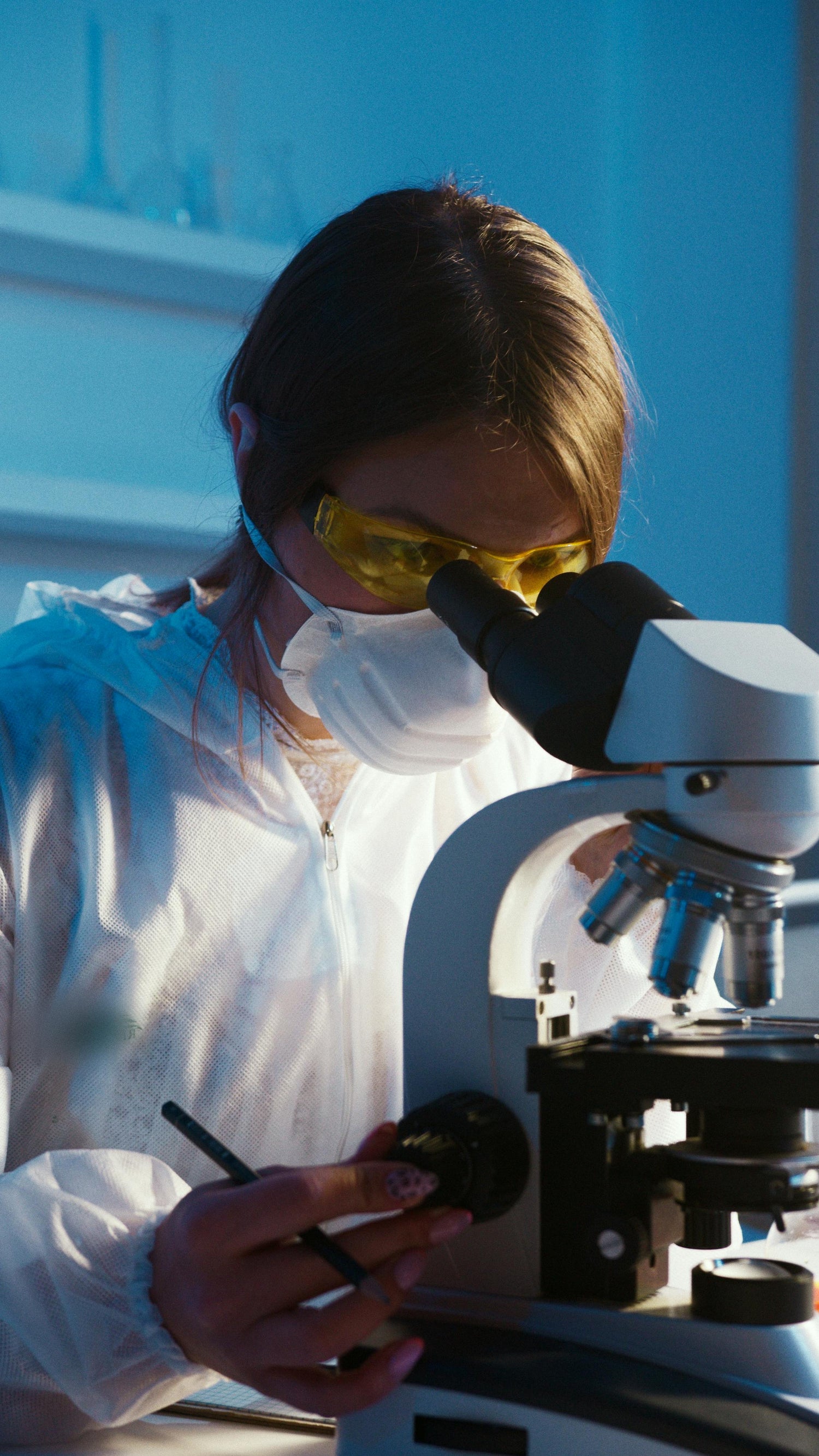 Picture of a lab technician using a microscope
