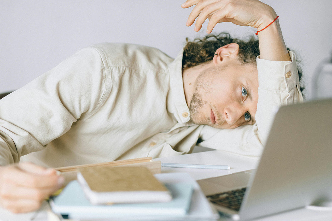 Guy Lying on a Desk, Looking stressed